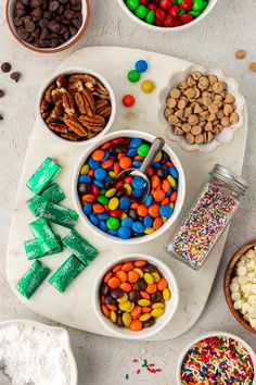 a table topped with bowls filled with different types of candy and candies on top of it