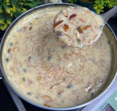 a ladle filled with food on top of a stove