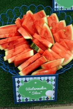 watermelon slices are cut into pieces on a blue plate with green and black border