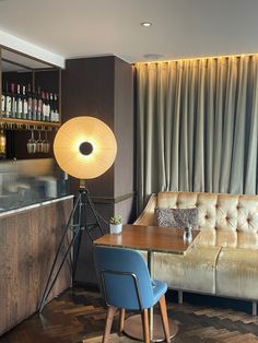 a living room with a couch, table and lamp in it's centerpiece