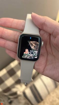 a person holding an apple watch in their hand