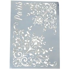 a piece of paper with white flowers on it and the word love written in silver foil