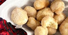 some sugar coated doughnuts in a white bowl