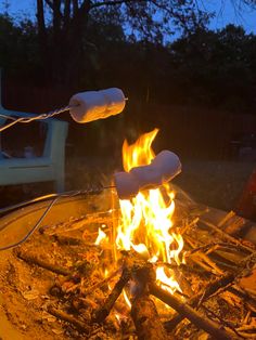 marshmallows roasting over an open fire pit