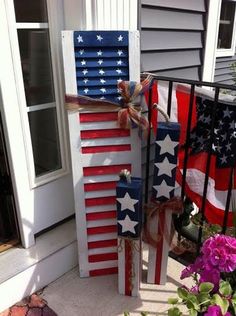 an american flag made out of old shutters on the front steps of a house