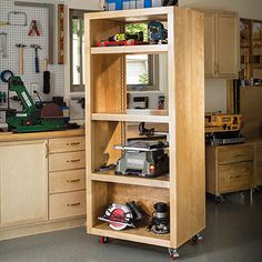 a workbench in a garage with tools on the floor and shelves full of woodworking equipment