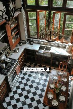 an old fashioned kitchen with black and white checkerboard flooring, stove top oven, sink, cabinets and windows