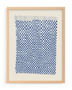 a blue and white checkerboard pattern is shown in a wooden frame on the wall