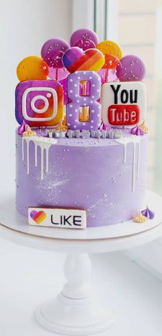 a birthday cake decorated with instagrams and balloons