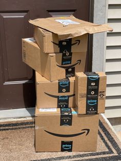 several boxes stacked on top of each other with the amazon logo painted on their faces