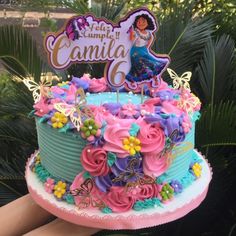 a birthday cake decorated with flowers and butterflies