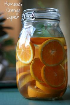 a jar filled with oranges sitting on top of a table