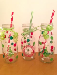 three decorated mason jars with straws and polka dots on the lids, one has a monogram