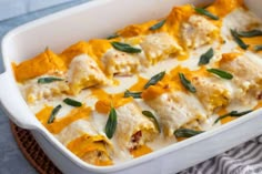 a casserole dish filled with cheese and vegetables