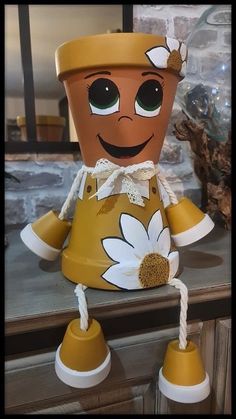 a potted plant with a smiling face on it's head sitting on a counter