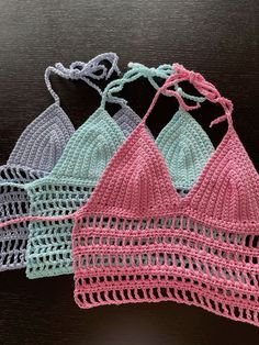 three crocheted bras are sitting on a table