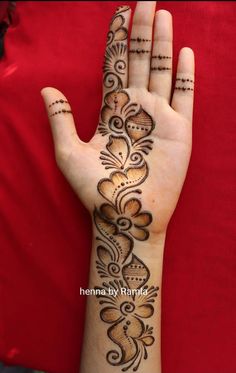 a hand with henna tattoos on it