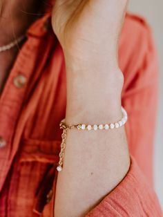 The Mother of all pearls! Ashley in Mother of Pearl with her tiny flecks of gold or silver is a fresh addition to your jewelry collection. Finished with a tiny, dangling pearl at the clasp makes this bracelet even more feminine and fun. Healing Properties: HarmonyAdaptabilitySensitivity We look for flashes of pearly iridescence from within the natural shell for each stone to give this simple bracelet the beauty and allure to be worn alone or stacked with others for even more impact. The unique h Adjustable Pearl Oyster Bracelet Jewelry, Dainty White Charm Bracelet For Everyday, Classic Pearl Bracelet With Extender, Dainty Pearl Drop Jewelry, Dainty Pearl Drop Bracelet, Classic Adjustable Chain Bracelet With Pearl Charm, Adjustable Bracelet With Pearl Charm, Adjustable Everyday Pearl Chain Jewelry, Pearl Jewelry With Oyster Bracelet And Round Beads