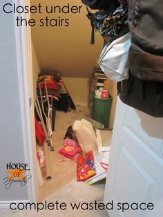 the closet is cluttered with clothes and other items in it, including a handbag