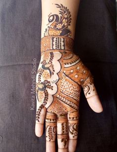 the hand is decorated with henna designs