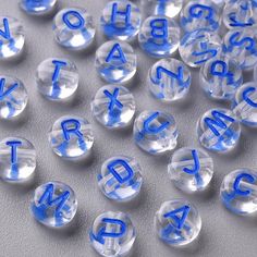 clear and blue letters are scattered on a white surface