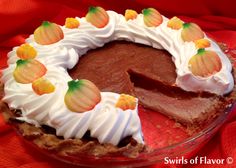 a chocolate pie with white frosting and pumpkins on top