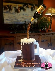 a beer being poured into a mug on top of a wooden block with white frosting