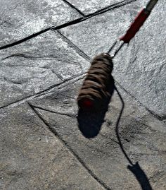 a dog is walking on the pavement with its leash attached to it's tail