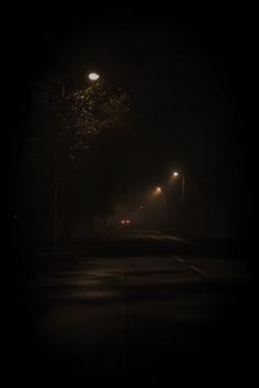 an empty street at night in the dark