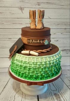 a cake that is on top of a stand with boots and other items around it