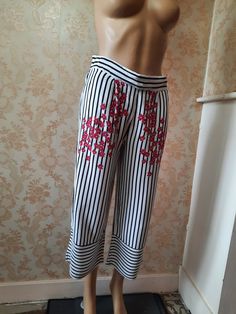 "Vintage striped cropped trousers with a pink floral patern on the top at front.  The back waist band is elasticated so they just pull on, the leg flares slightly and has the stripes going the other way.  These are lovely and cool to wear and in very good condition.  There are two side pockets Waist;  30\" Hips;  40\" Inside leg;  22\"  Width at hem;  10\" Made by ZARA viscose" Pattern Palazzo Pants, Libby Smith, Cropped Palazzo Pants, Womens Trousers, Womens Pants, Vintage Pants, Cropped Trousers, Palazzo Pants, Pants Trousers