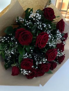 a bouquet of red roses and baby's breath