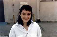 a young woman standing in front of a building