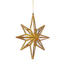 a gold star ornament hanging from a string