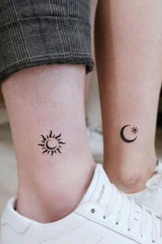 two people with matching tattoos on their feet, one has a sun and the other has a crescent