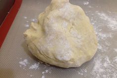 a ball of dough sitting on top of a cookie sheet