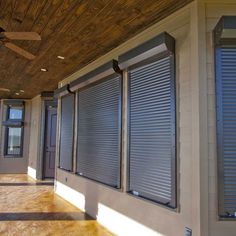 the inside of a building with several windows and shutters on each side of the wall