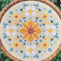 a cross stitch pattern on a wooden hoop