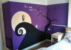 a bedroom decorated in purple and black with a halloween scene painted on the wall next to the bed