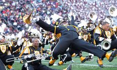 a marching band performing on the field at a football game