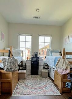 a room filled with lots of wooden furniture and bunk beds next to two large windows