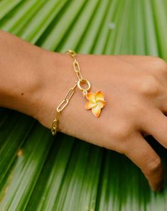 Leilani means heavenly flower in Hawaiian language. This charm is inspired from Plumeria flower which are found widely in Hawaii. They have the sweetest fragrance with gorgeous shades. This charm is handcrafted using 18k gold plated brass and are hand painted with the colors as seen on plumeria flowers. You can slip this charm on simple cable chain, pearl link chain or a paper clip bracelet. Paper Clip Bracelet, Hawaiian Language, Plumeria Flowers, Semi Precious Jewelry, Sweet Fragrances, Silver Moon, Bangle Set, Silver Cuff, Paper Clip