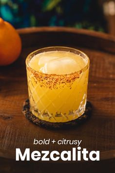 a glass filled with liquid sitting on top of a wooden table