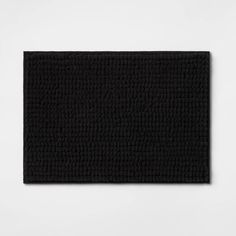 a black bath mat on a white background