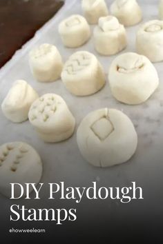 there are many small white buttons on the tray with words diy playdough stamps