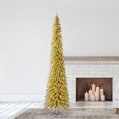 a living room with a christmas tree in the corner and candles on the floor next to it