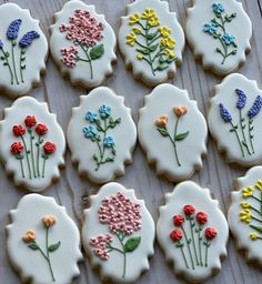 decorated cookies with flowers on them sitting on a table