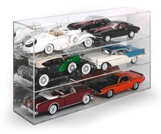 an acrylic display case filled with various model cars