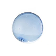 a blue glass object sitting on top of a white surface