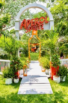 the entrance to an orange and white garden